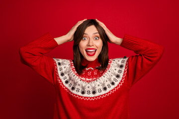 Poster - Photo of impressed astonished girl with straight hairstyle wear red sweater arms on head open mouth isolated on red color background