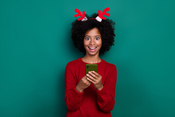 Sticker - Photo of impressed funny small schoolgirl wear red pullover hairband chatting samsung modern device isolated green color background