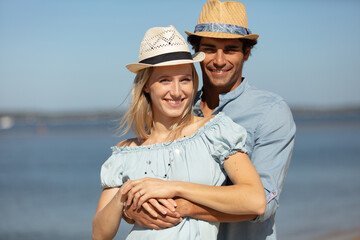 Wall Mural - young couple relaxing at the beach