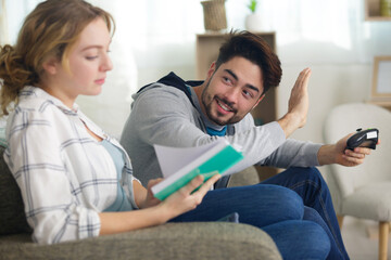 Wall Mural - man playing video games and woman reading book