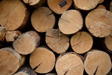 brown logs, firewood for home heating in winter, pine, oak logs, wood, heating in winter, without gas and electricity, preparation for winter to keep warm in winter, even firewood cut and stacked symm