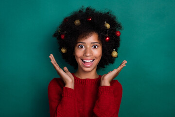 Poster - Portrait of crazy positive girl raise hands palms toothy smile tree toys hair isolated on green color background