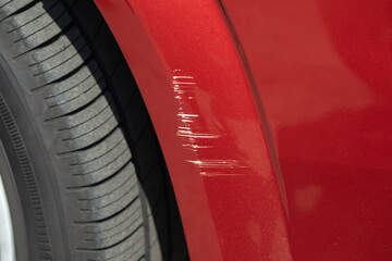 Scratching on the front of the car's wing in a car repair shop.