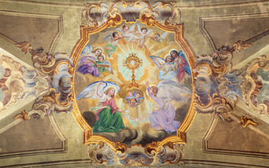 Wall Mural - VARALLO, ITALY - JULY 17, 2022: The baroque ceiling fresco of Eucharistic adoration of angels in the church Collegiata di San Gaudenzio by Carlo Bartolomeo Borsetti (1702).