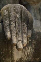 Close-up shot on the Hand of a dirty Buddha statue