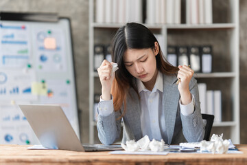 Wall Mural - Stressed Asian business woman worry about marketing plan of this years. Account, Real Estate Agent, Finance concpet