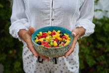 Crop Woman With Bowl Of Fruit Salad