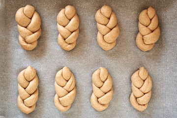 Wall Mural - Praparation of braided bread buns from whole grain spelt flour, top view