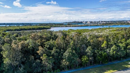 Poster - View of a road next to seashore near Settlement Point surrounded by green trees Port Macquarie, NSW