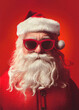 © ADDICTIVE STOCK - Santa Claus with red glasses on red background