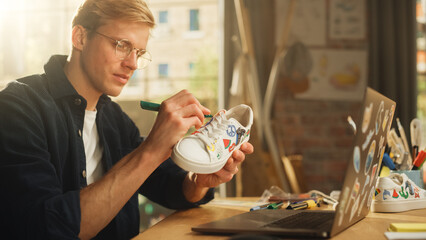 Aufkleber - Caucasian Male Artist Creating Fresh Design on Sneakers in Loft Working Environment. Handsome Man Drawing on Shoes, Creative Occupation and Fashion Startup Company Concept.