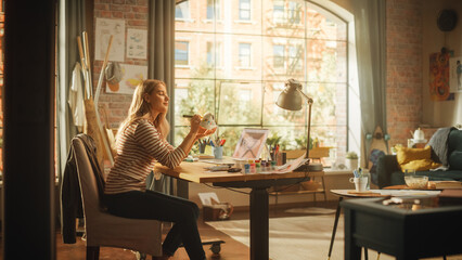 Aufkleber - Blonde Female Artist Feeling Satisfied While Refreshing Old Sneakers in Front of her Laptop Computer in Creative Environment. Girl Drawing on Shoes in Loft Living Room. Fashion Concept.