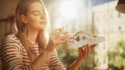 Aufkleber - Female Fashion Designer Full of Ideas and Creating Design for Used Pair of Sneakers. Teenager Artist Looking at Laptop and Drawing on Shoes. Custom Made and Eco Friendly Clothes Concept.