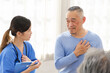 © artitwpd - The caregiver therapist sits with a group of Asian senior people in a circle for checking physical and mental health in a group elderly therapy session. The nursing home facilitates a support group