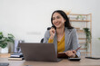 © wichayada - Portrait of an Asian young business Female working on a laptop computer in her workstation.Business people employee freelance online report marketing concept.