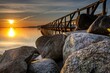 Pier from behind rocks in Harrislee on the Baltic Sea at sunrise