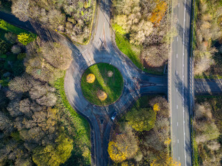 Canvas Print - Aerial view of a traffic roundabout surrounded by autumn trees (Wales)