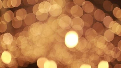 Wall Mural - Abstract golden blurred christmas lights bokeh background. Beautiful luminous shimmers, blinking Christmas Tree lights twinkling. Winter holidays concept. Defocused lights with bokeh sparkle pattern