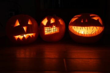 Wall Mural - Pumpkin lanterns on a wooden background.