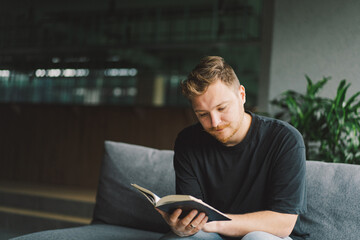 Wall Mural - Christian man holds holy bible in hands. Reading the Holy Bible in a home. Concept for faith, spirituality and religion. Peace, hope