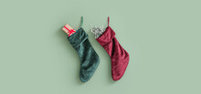 Christmas Socks With Gifts Hanging On Light Green Wall