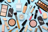 Fototapeta Kawa jest smaczna - Cosmetics, accessories and sale tags on blue background