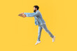 © Pixel-Shot - Handsome bearded man with clipboard jumping on yellow background