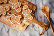 A rustic, festive baking scene with gingerbread men and gumdrops, on a marble worktop background. Perfect for the Christmas holiday season. 