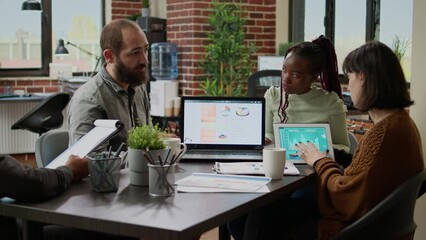 Canvas Print - Diverse team of business people working on research report, doing collaboration meeting in boardroom office. Coworkers brainstorming ideas and analyzing project charts, networking data.