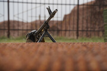 Almaty, Kazakhstan - 04.14.2022 : A Kalashnikov assault rifle is mounted against the background of a number of ammunition.