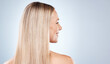 © M Einero/peopleimages.com - blonde happy woman, with healthy straight hair aesthetic on blue background in studio and flat iron hair care. Young girl with clean hair, side profile beauty with natural shine and luxury shampoo