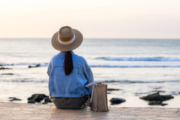 Sticker - Travel woman sit at the seaside under sunset time