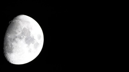 Wall Mural - Timelapse. A glowing huge moon seen from earth through the atmosphere against a starry night sky. A large moon moves across the sky, the moon moving from the left frame to the right.