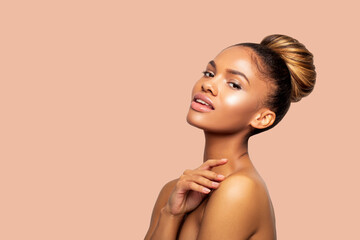 Wall Mural - Young African American Woman with Perfect healthy smooth Skin touches her neck with her hand and looks at the camera. isolated. Fashion Portrait of a beautiful black woman in profile, light makeup    