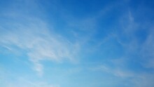 4K Sky Time Lapse, Beautiful Background, Sky Timelapse Of Horizon, Clouds And Sun. Weather And The Movement Of Nature Concept. Clouds At Blue Sky

