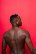 © Ivan Zelenin - One young handsome african man topless portrait in studio on red background