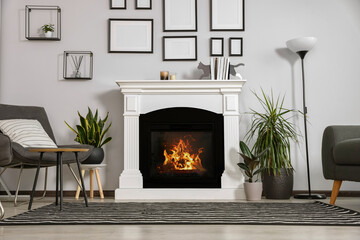 Sticker - Stylish living room interior with fireplace, grey armchairs and side table