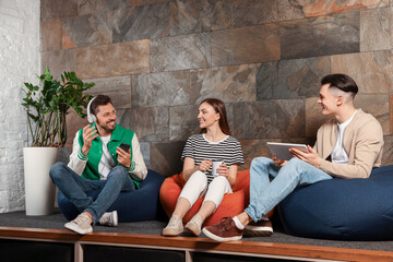 Poster - Office employees enjoying break together in recreation room at work