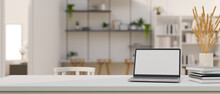 Modern Bright Workspace With Laptop Mockup Over Blurred Modern Co-working Space In Background.