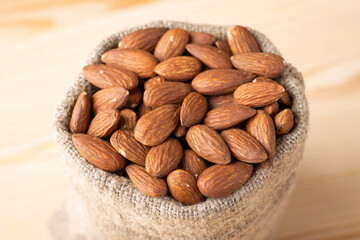 Wall Mural - Close up shot of bag of almond. Full linen bag of almond nuts