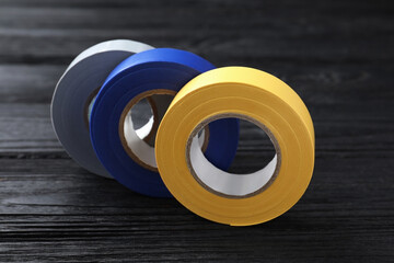 Sticker - Colorful insulating tapes on black wooden table