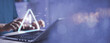 © Montri - Businessman using computer laptop with triangle caution warning sing for notification error and maintenance concept...