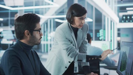 Poster - Two Industrial Design Agency Specialists Discussing a 3D Circuit Board Model Created on a CAD Software on Desktop Computer. Young Man and Female Working in Electronics Development Factory.