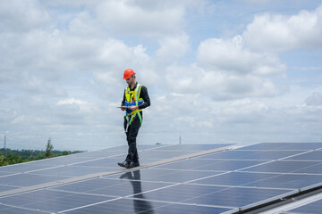 Poster - Engineers checking solar panel on the roof of factory.