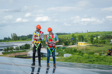 Aufkleber - Technician wearing safety harness belt during installing the solar panels on roof structure of building factory,Economic energy and cost saving concept.