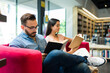 © AntonioDiaz - Young couple checking some books out and reading at a bookstore