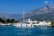 Super luxury Yacht moored in marina. Sunny weather. View from sea. Yachting, cruising, vacations, recreation concept.
