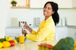 © Prostock-studio - Happy fit african american woman writing daily ration diet or menu in notebook, sitting at kitchen table, copy space