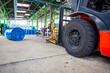 © chitsanupong - Forklift wheel lifts chemical drums oil barrels blue chemical drums horizontal