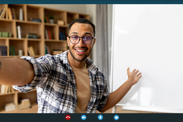 Poster - Distance education concept. Smiling arab male tutor having video call, sitting near whiteboard and talking to camera